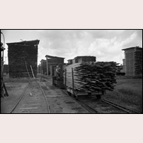 Rönneshytta sågverk i augusti 1967. Sågverksarbetaren Birger Schwartz (1902-1993) kör det större av dieselloken från sågen till järnvägsstationen. Sågen är nedlagd så bara tömning av virkeslagret återstår. Bild från Örebro läns museum. Foto: Okänd. 