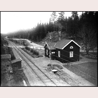 404 Noravägen. Bilden är tagen tidigast 1932 (då elektrifierades bandelen) och senast 1950 (det år då fotografen gick bort). Vägen med bilen är den gamla huvudvägen från Katrineholm mot Norrköping; den nuvarande riksvägen går ett stycke till höger utanför bilden. Foto: Carl Werngren. 