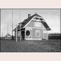 Suntak station, troligen kort tid efter öppnandet 1906. De tre flaggstängerna kan antas ha använts vid någon invigningsceremoni. Bild från Sveriges Järnvägsmuseum. Foto: Okänd. 