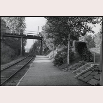 Strömnäs hållplats omkring 1948. Bilden är tagen i nordlig riktning och tänkt att framför allt visa vägbron. Därför är hållplatsstugan nätt och jämt synlig i högra bildkanten. Bild från Järnvägsmuseet. Foto: Okänd. 